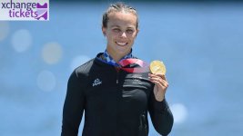 Lisa Carrington Olympic gold medal kayak celebration water race.jpg