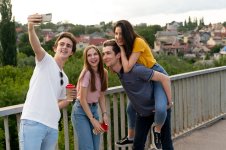 group-four-friends-spending-time-together-outdoors-taking-selfie_23-2149023686.jpg